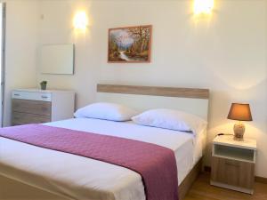 Postel nebo postele na pokoji v ubytování Zlatko Apartments
