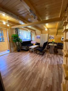 a large living room with wooden floors and a couch at Komfortowe Domki Dar in Sianozety