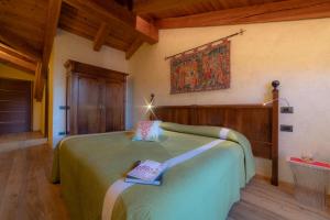 a bedroom with a green bed with two books on it at Wine-Farm La Source in Saint-Pierre