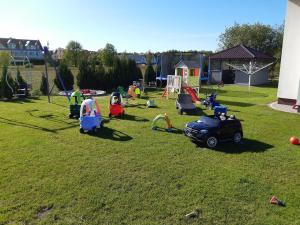 a group of children playing in a yard at Apartamenty Bursztynowe in Dębki