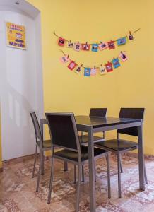 a dining room table and chairs with clothes pins on a yellow wall at PANORAMI Apart Hostel in Lviv in Lviv