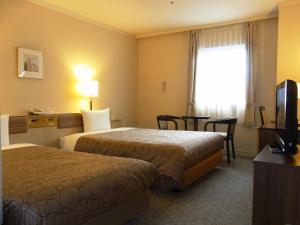 Postel nebo postele na pokoji v ubytování Asakusa Central Hotel