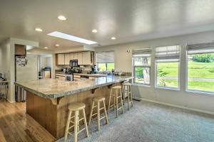 a kitchen with a large island with bar stools at Spacious Family Home on Golf Course Hike and Bike! in Bremerton