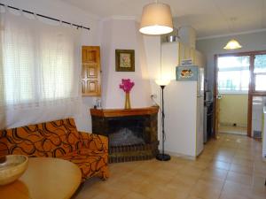 a living room with a couch and a fireplace at Casa Mediterráneo in La Marina