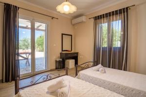 Postel nebo postele na pokoji v ubytování Villa Kallisti