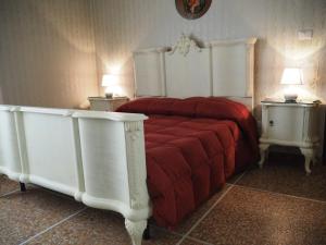 una camera con letto rosso e 2 comodini di Bel Fiore a San Benedetto del Tronto