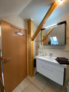 a bathroom with a sink and a mirror at Haus Stegmeir in Hohenweiler