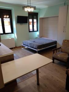 a bedroom with a bed and a couch and a table at Residencias Turísticas Matasiete in León