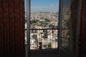 een raam met uitzicht op de stad bij Tabar Hotel in Nazareth