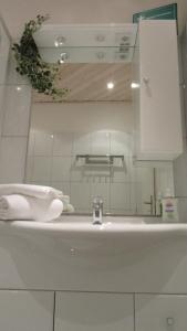 a white bathroom sink with a faucet at Bike & Ski kappe, am Bikepark, Skilift in Winterberg +24 photos