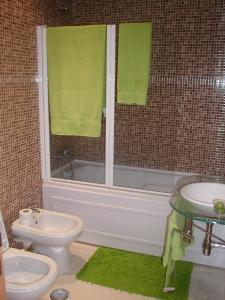 a bathroom with a tub and a toilet and a sink at Luxury quiet apartment with private pool near the beach and mountains in Algarve in Portimão +7 photos