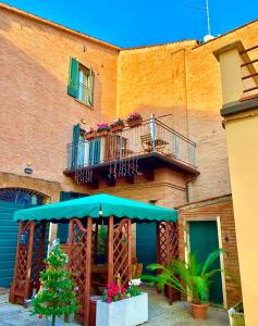 a building with a balcony with a christmas tree on it at Le Stanze sul Po in Ferrara