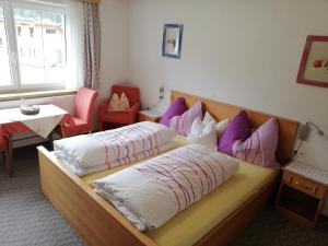 A bed or beds in a room at Pension Tannheim