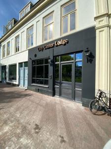 a store front of a building with a bike parked outside at City Center Lodge Utrecht in Utrecht