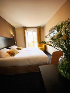 um quarto de hotel com uma cama e uma janela em Hotel Molière em Cannes