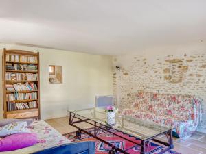 a living room with a couch and a glass table at Spacious Holiday Home in Sauveterre de l mance in Sauveterre-la-Lémance