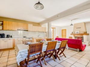 a kitchen and dining room with a table and chairs at Spacious Holiday Home in Sauveterre de l mance in Sauveterre-la-Lémance