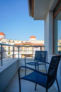 two chairs sitting on a balcony with a view at Obzor Tatyana Apartaments Art in Obzor
