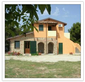 a large house with green shutters on it at Agriturismo Nakelia in Zambrone
