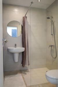 a bathroom with a sink and a shower and a toilet at Obzor Tatyana Apartaments Bonjour in Obzor +10 photos