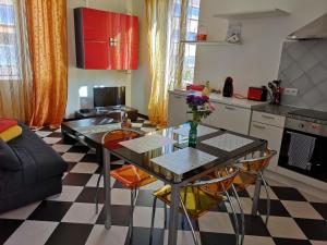 a kitchen with a table and chairs in a room at Chez Fifine in Roquebrune-Cap-Martin