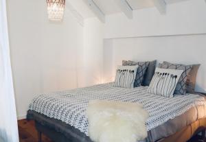 a bedroom with a bed with a white comforter at Het Wijdeland in Zwolle