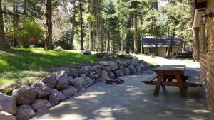 a picnic table next to a stone wall at Eagle Cap Chalets in Joseph