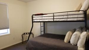 a bedroom with two bunk beds and a window at Eagle Cap Chalets in Joseph