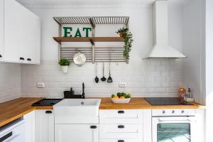 a kitchen with white cabinets and a counter top at Alfama Chic Rua dos Remédios in Lisbon