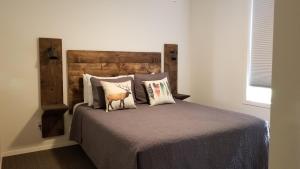 a bedroom with a bed with a wooden headboard and pillows at Eagle Cap Chalets in Joseph