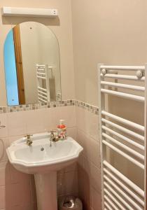 a bathroom with a white sink and a mirror at Ellen House Bed and Breakfast in Matlock