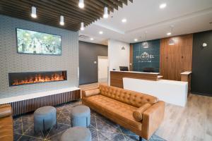 a lobby with a couch and a fireplace at Microtel Inn & Suites by Wyndham Kelowna in Kelowna