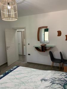 a bedroom with a bed and a tv on the wall at Apartman Višković Koromačno in Koromačno +5 photos