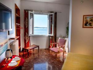 a living room with a view of the ocean at Casa Sulla Laguna in Murano
