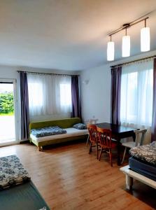 a living room with a table and a couch at Noclegi Małgorzatka in Solec-Zdrój