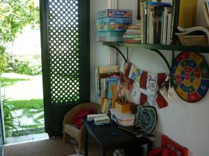 a room with a table and a shelf with books at Casa Picva in Óbidos