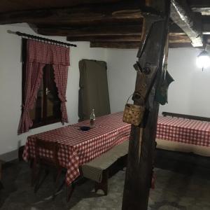 a table in a room with a red and white checkered table cloth at Etno selo Milanovic - Nonac in Kuršumlija