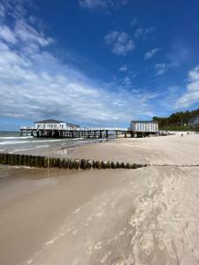 a view of a beach with a pier and the ocean at Komfortowe Domki Dar in Sianozety