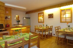 a dining room with wooden tables and chairs at Chata Panorama Beskidów in Ustroń