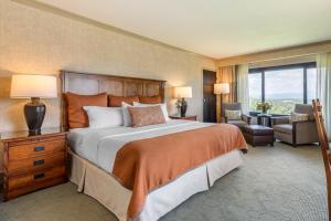 a large bedroom with a large bed and a chair at The Omni Grove Park Inn - Asheville in Asheville