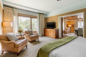 a hotel room with a bed and a television at The Omni Grove Park Inn - Asheville in Asheville