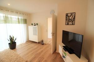 a living room with a large flat screen tv at Ferienwohnung Feldblick in Hartheim