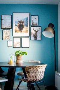 a table with pictures of animals on a blue wall at Studio Puuur in Zandvoort