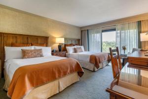 a hotel room with a large bed and a large window at The Omni Grove Park Inn - Asheville in Asheville