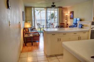 a kitchen with a view of the ocean from the dining room at Hale Kai O'Kihei 309 in Kihei