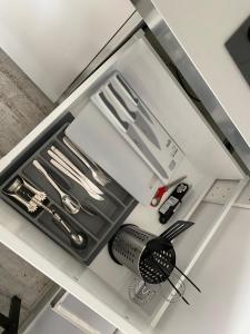 a white drawer with utensils in a kitchen at 123 Aurora Bydgoszcz in Bydgoszcz