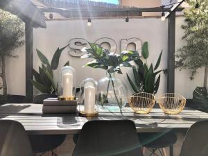 a table with candles and plants in front of a wall at VUT iDesign in Ávila