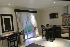 a kitchen with a table and chairs and a window at Nations Lodge in Lynchfield