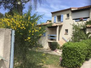 a house with yellow flowers in front of it at Clos des Cailloux in Prades-le-Lez