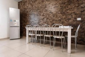 a table with chairs and a refrigerator in a room at Cottage Exclusive & dom4 in Grodno